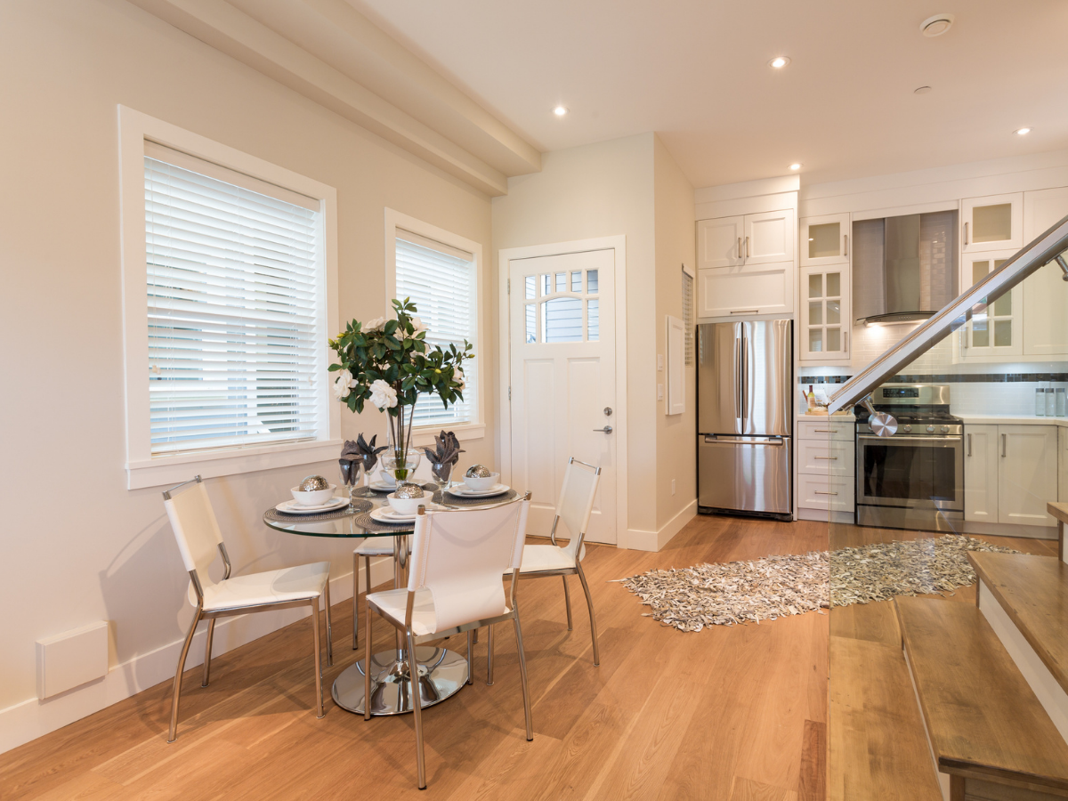 Bright kitchen and dining area with warm wood floors
